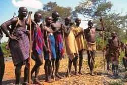 Group of Mursi people with traditional clothing and tools